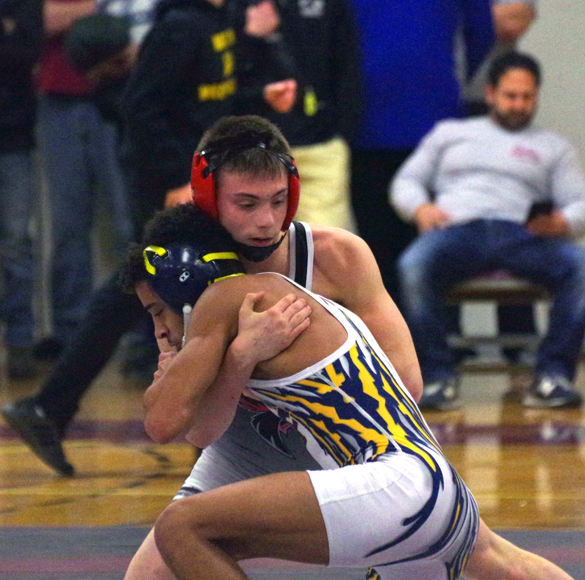 Collin Coughenour (red helmet) wrestles versus Michael Snowden of Niagara Falls in the 120-pound class. Coughenour defeated Snowden to win his second Section VI title. (Photos by Larry Austin)